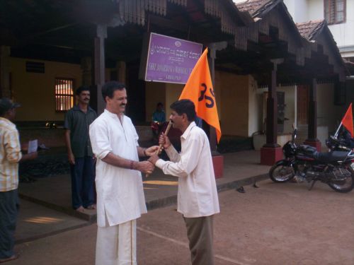 Dr. Ballal - Dharmadarshi of Temple handing over Dharma Dhwaja